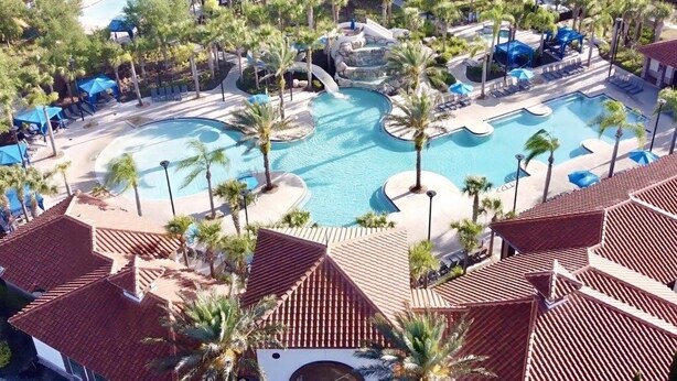 A resort with multiple swimming pools, palm trees, and covered areas.