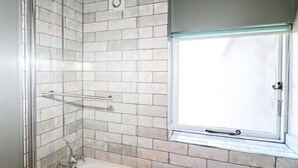A bathroom with a shower, a window, and a towel rack. - Well Cottage - 2 bedroom (sleeps 4) (Ashbourne)