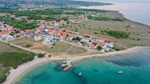 An aerial view of a coastal town with houses, a beach, and boats. - Luxury villa Marko, family-friendly and pet-friendly modern villa near sea.

 (Vir)