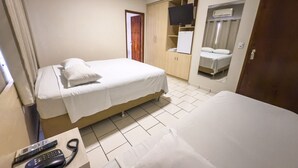 A hotel room with two beds, a TV, a wardrobe, and a mirror. - Hotel Parati Arapongas (Arapongas)