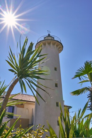 Standing tall amidst lush greenery, this iconic lighthouse offers a serene escape.