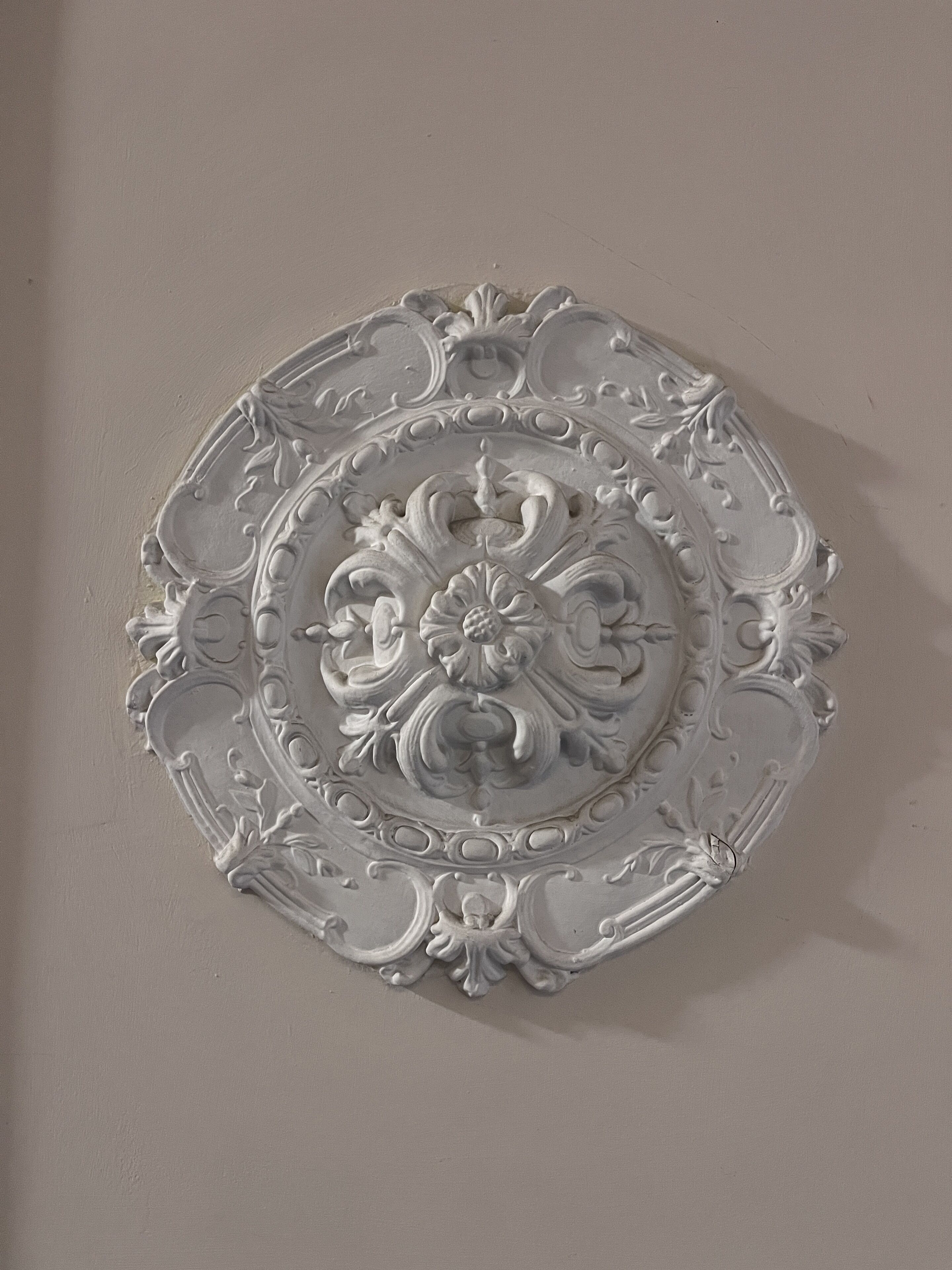 A decorative plate with intricate floral and scroll designs.