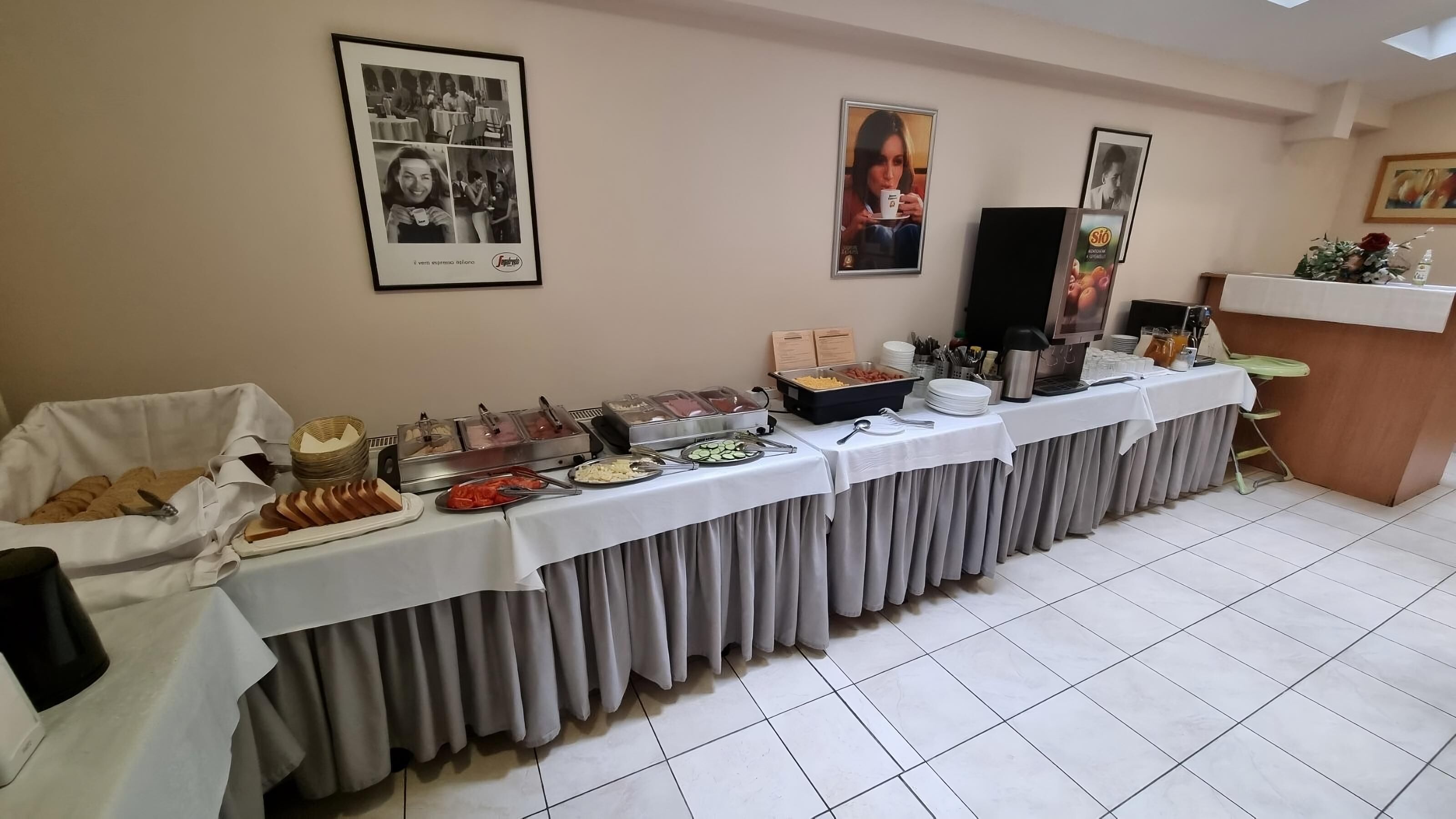 A buffet setup with various food items and a coffee station.