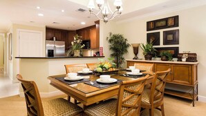 A dining area with a wooden table, chairs, and a chandelier. - Serenity Apt - Tranquil and Cozy Orlando Apartment (Kissimmee)