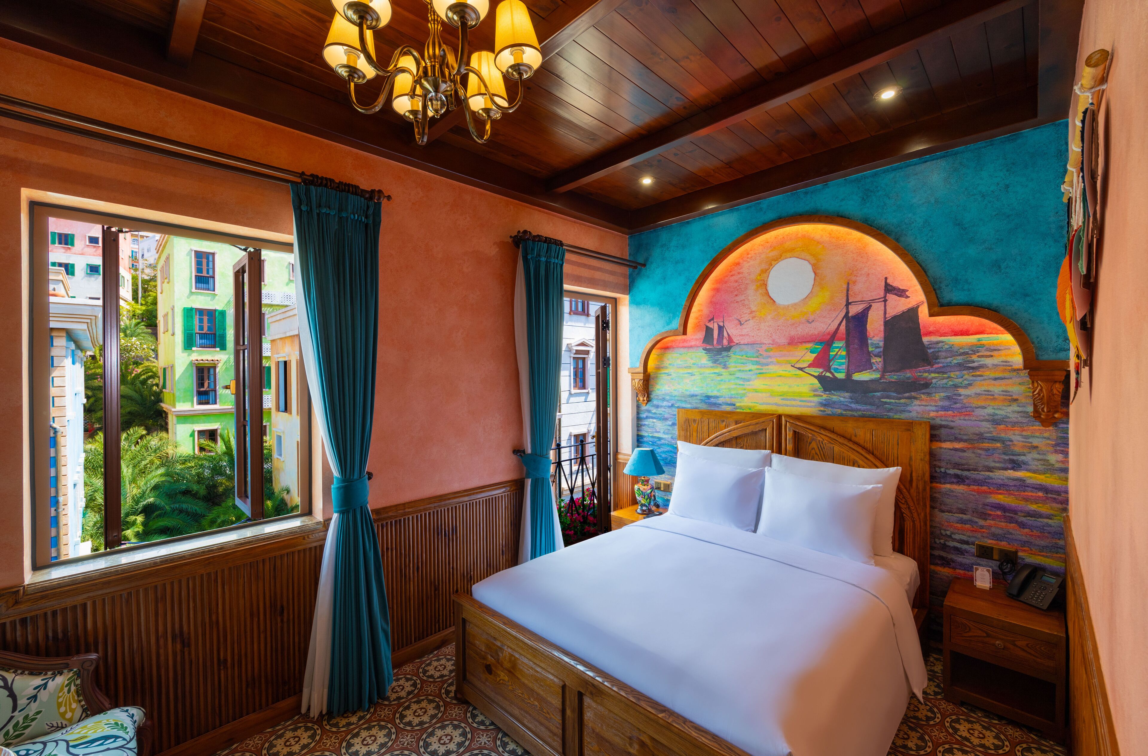 A well-appointed hotel room with a large bed, a view of colorful buildings through a window, a mural on the wall, and a wooden ceiling.