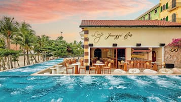 A poolside bar with outdoor seating and a view of the pool.