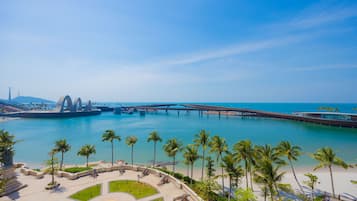 A coastal resort with a marina, palm trees, and a bridge.
