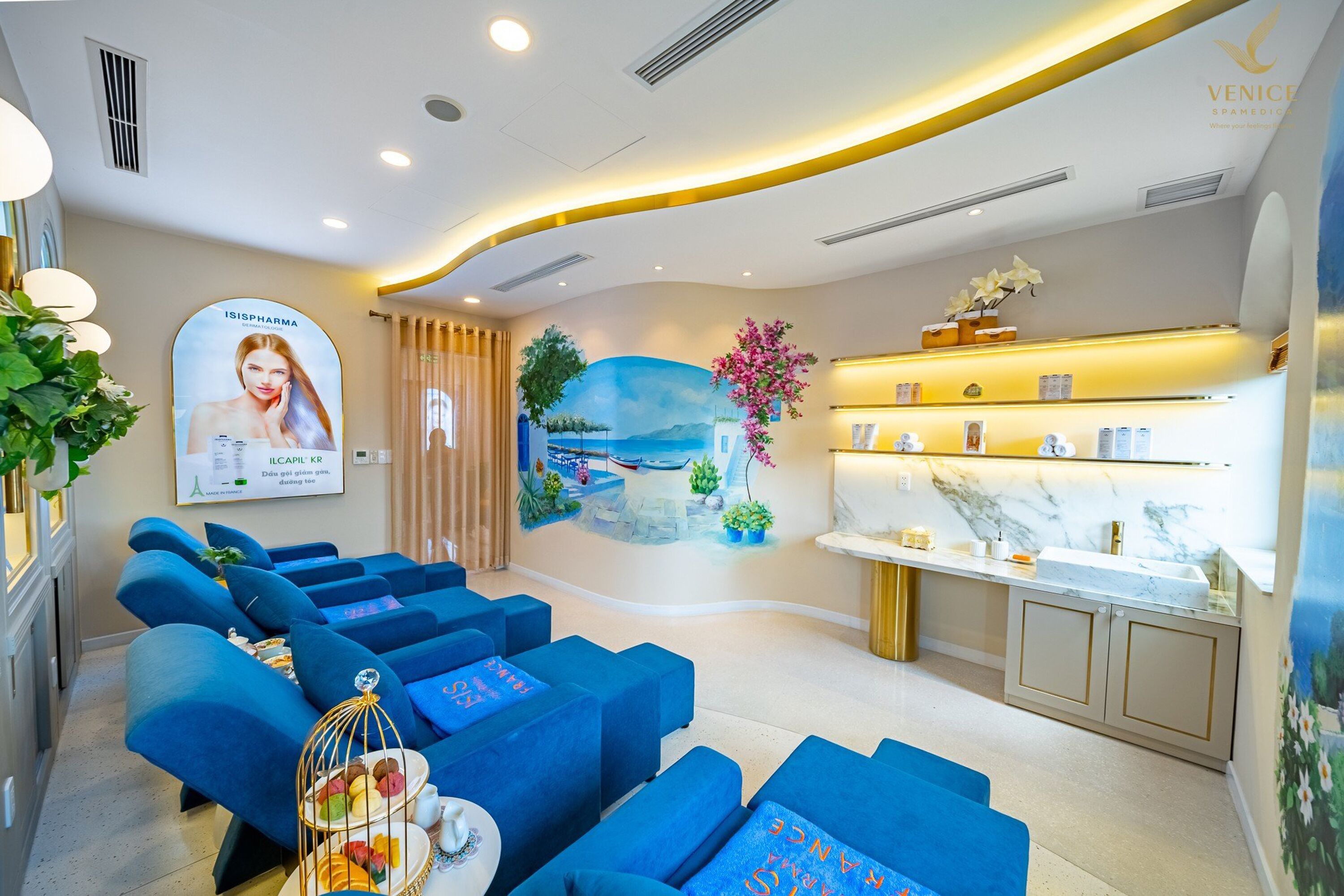 A modern spa area with blue seating, a mural, and a reception desk.
