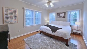 A bedroom with a bed, a ceiling fan, and a window with blinds. - 50s Retro residence in picturesque neighborhood (Jackson)