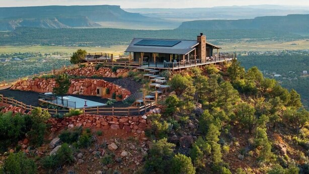 A lodge with a patio area and a view of the surrounding landscape.