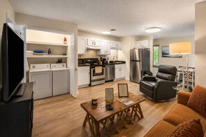 A compact living space with a kitchenette, a dining area, and a seating area.