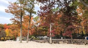 A sandy beach area with trees displaying autumn foliage. - Pocono Retreat -1 Mile to Lake and Skiing (Lake Harmony)