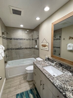 Enjoy a refreshing soak in the large bathtub or invigorate in the separate shower area.
