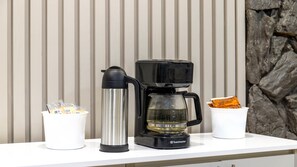 A Toastermaster coffee maker on a white countertop with a white mug and a stainless steel water bottle. - Motel 6 – Cornwall, ON (Cornwall)