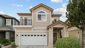 A two-story house with a garage, a balcony, and a well-maintained lawn. - Luxury Lakefront Escape with Stunning Views at Sparks Marina (Sparks)