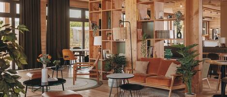 A spacious living area with wooden furniture, built-in bookshelves, and a view of the outdoors.