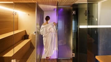 Relax in a serene spa area with a glass-enclosed space, wooden bench, and sign for easy access.
