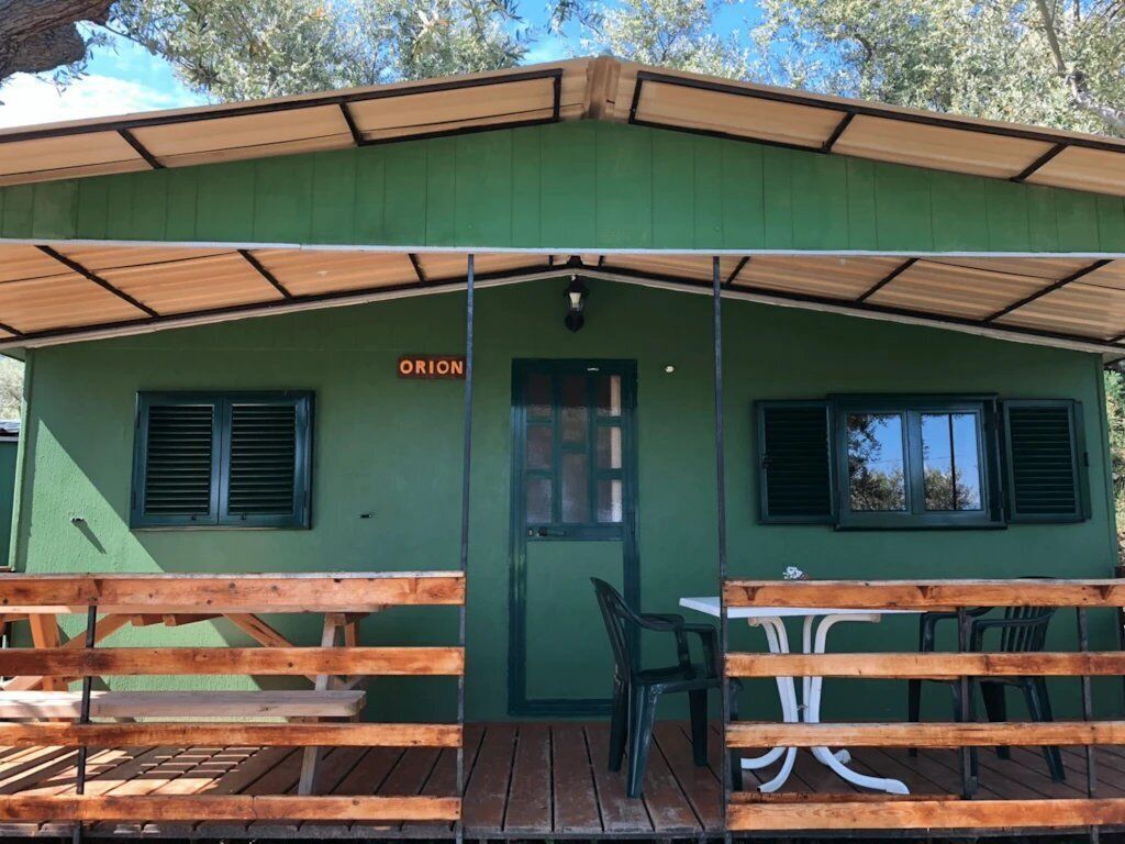 A green building with a sign reading "ORION" above the door.