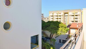 A multi-story building with balconies and a clear sky.