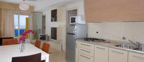 Fridge, microwave, stovetop, cookware/dishes/utensils