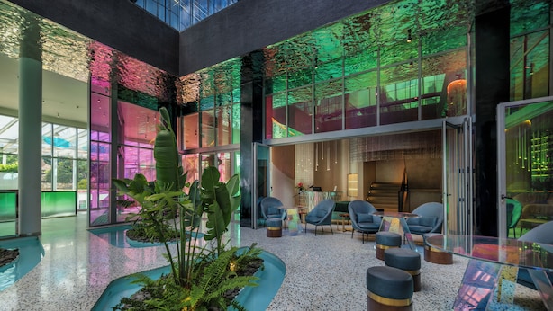A spacious lobby with a glass ceiling, seating area, and indoor plants. - Gem Forest Hotel Nairobi - MGallery Collection (Nairobi)