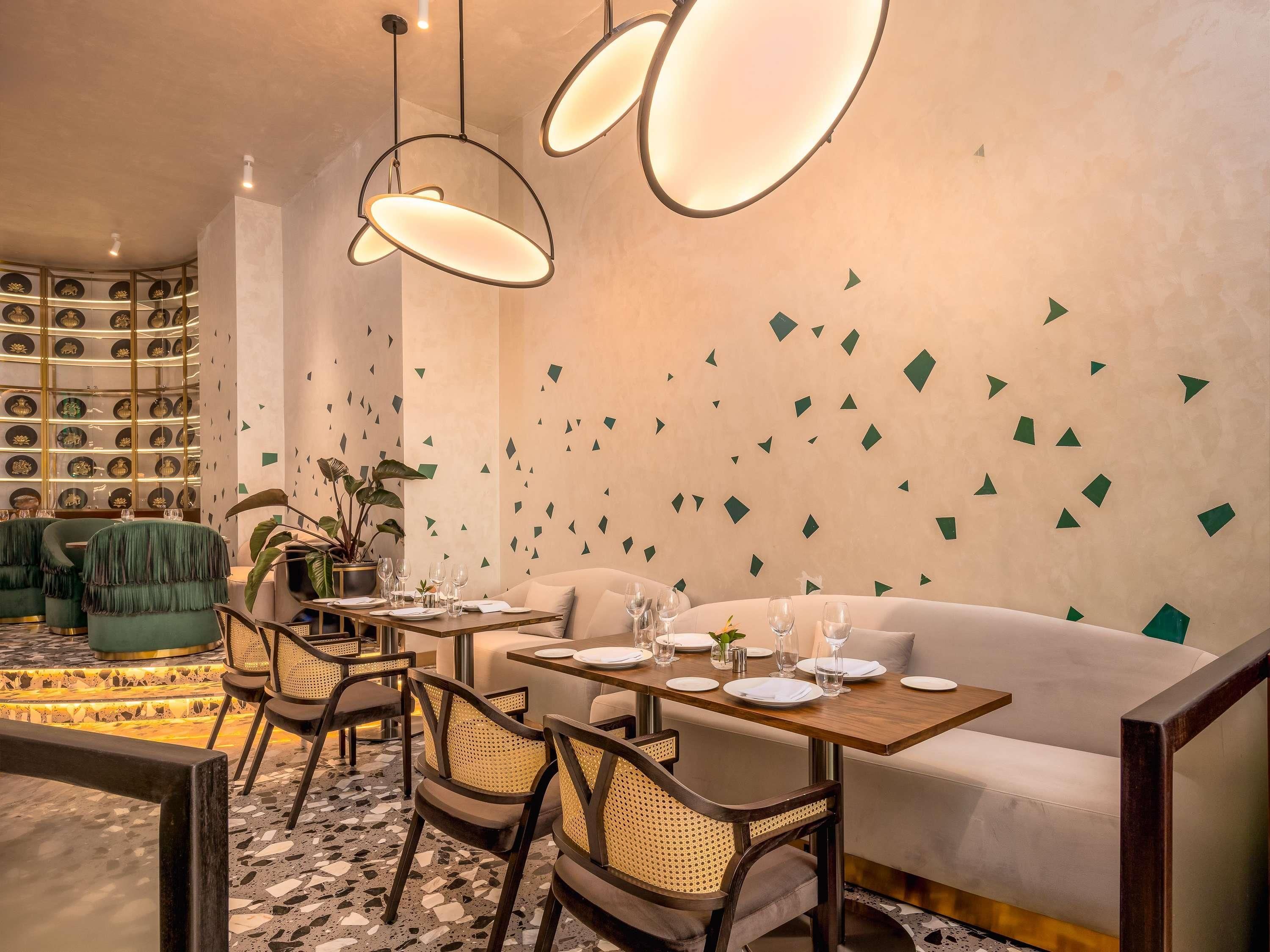 A dining area with a round table, chairs, and a sofa.