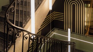 A staircase with ornate metal railings and modern light fixtures. - Hotel Fort St Laurent Lyon - Handwritten Collection (Lyon)