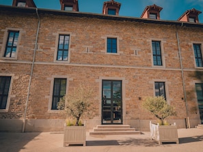 A multi-story stone building with large windows and a central entrance. - Hotel Fort St Laurent Lyon - Handwritten Collection (Lyon)