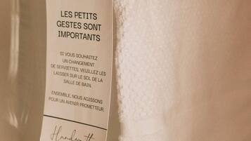 A tag with text in French, possibly from a hotel or accommodation, mentioning a change in services or amenities.