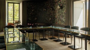 A conference room with a long table, chairs, and a floral wallpaper. - Hotel Fort St Laurent Lyon - Handwritten Collection (Lyon)