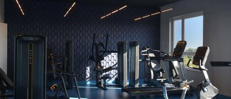 A modern gym with various exercise equipment, a patterned wall, and a large window providing natural light.