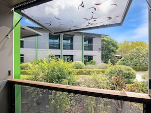 A modern building with a large glass facade, surrounded by well-maintained greenery and a clear sky. - Ibis Darwin Airport Hotel (Eaton)