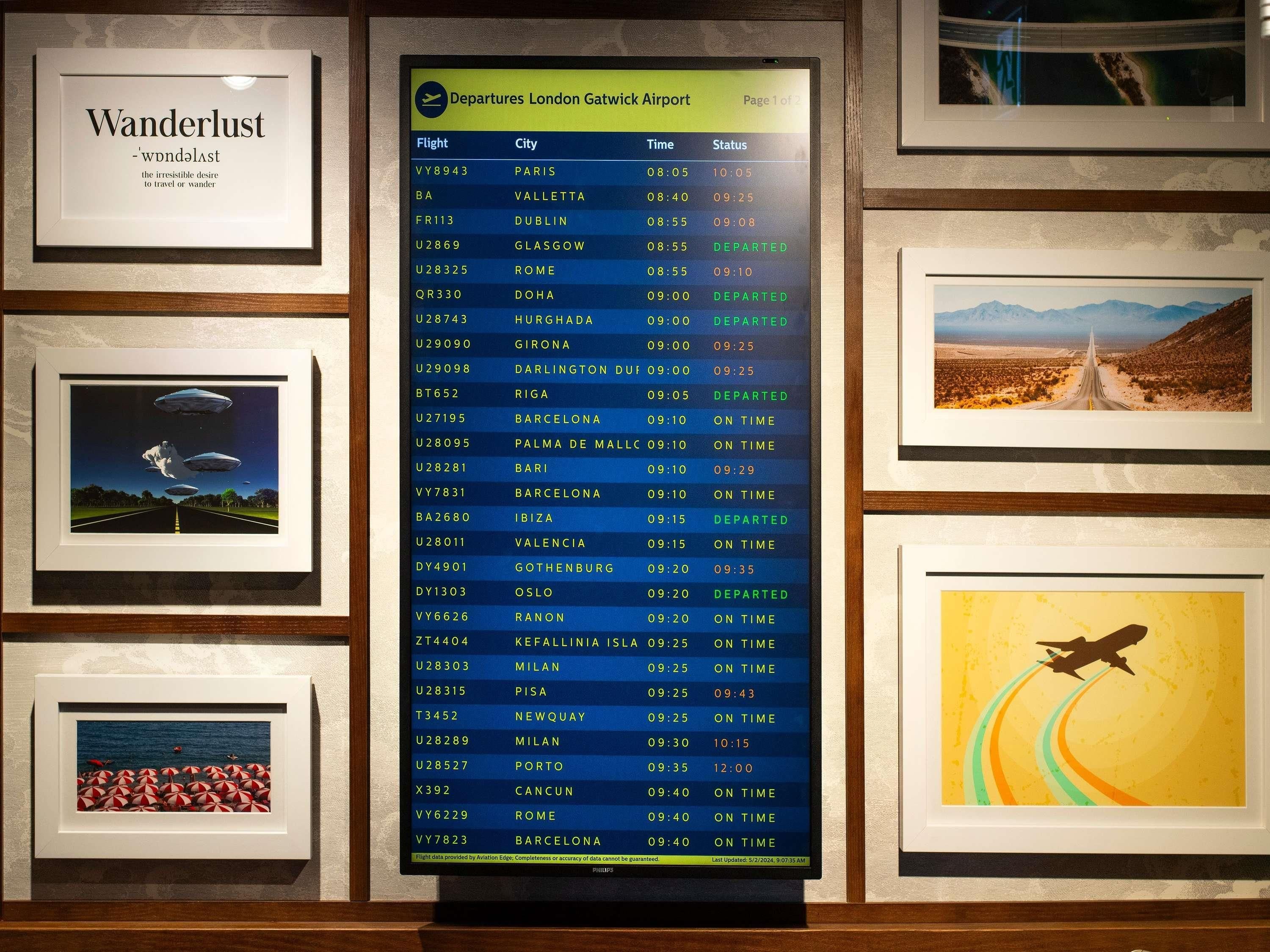 A departures board at London Gatwick Airport with flight information.