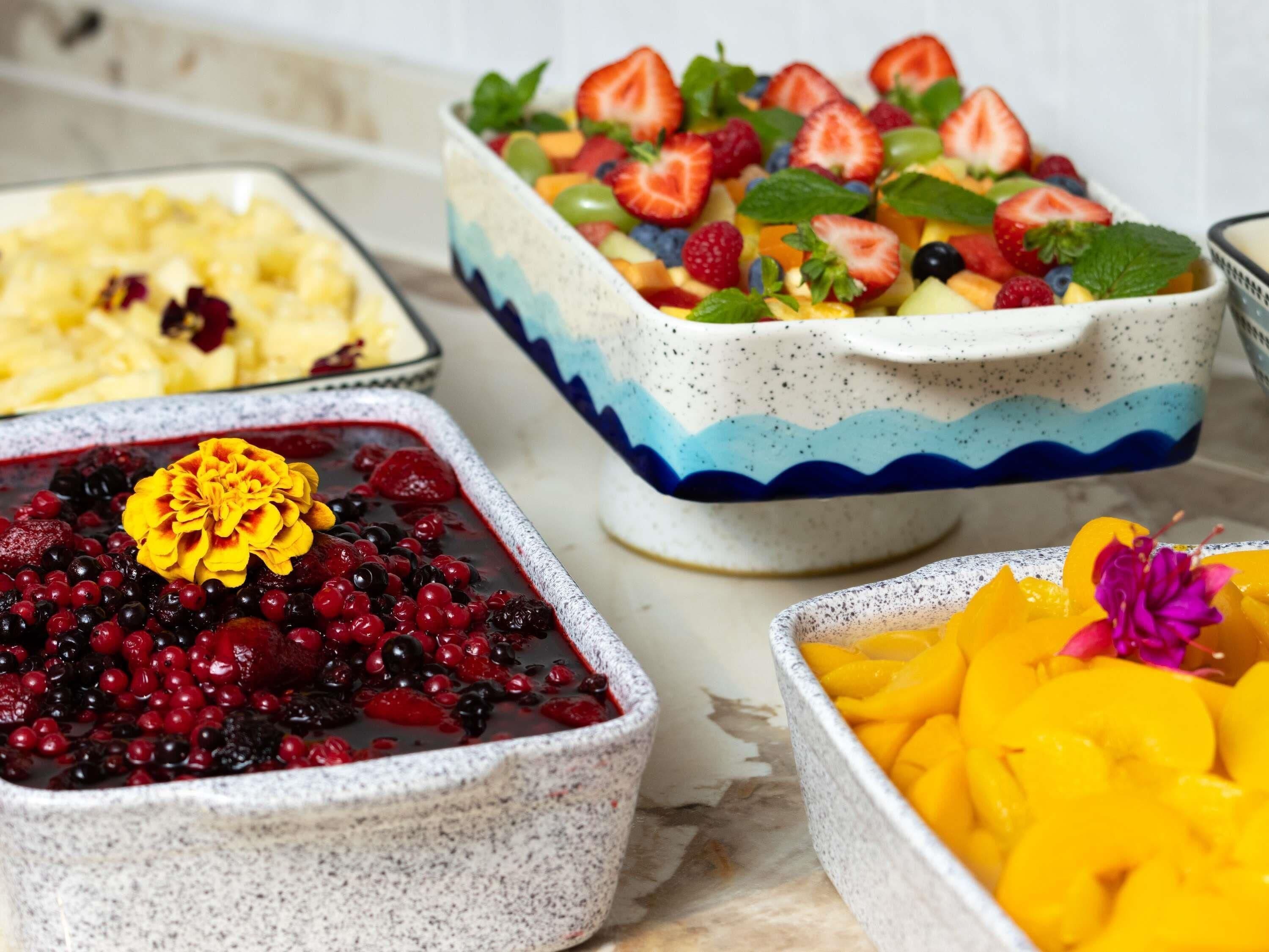 A variety of fruit dishes in ceramic bowls.