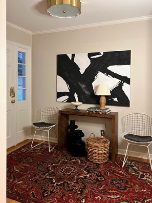 Traditional entryway with a console table, lamp, and artwork.