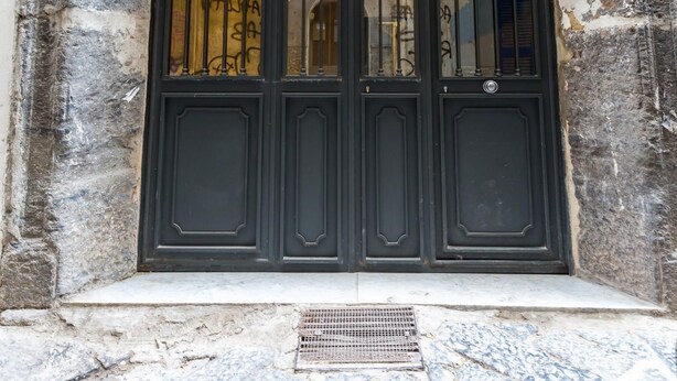 A black double door with a metal gate, a "No Parking" sign, and a small mailbox on the left. - Napoli Street Art Rooms - Wall by Wonderful Italy (Naples)