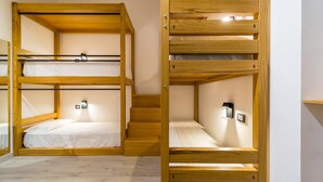 A room with two bunk beds, wooden flooring, and a small staircase. - Napoli Street Art Rooms - Wall by Wonderful Italy (Naples)