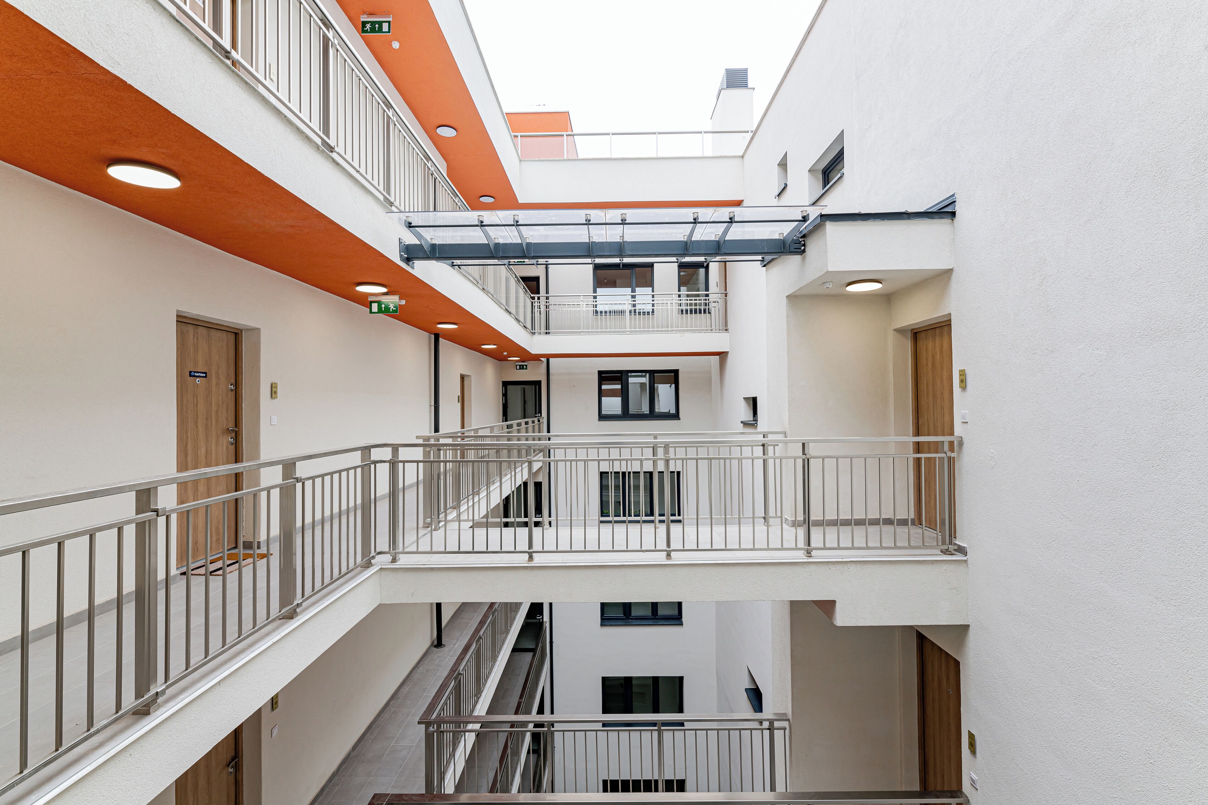 A multi-level atrium with balconies, staircases, and doors.