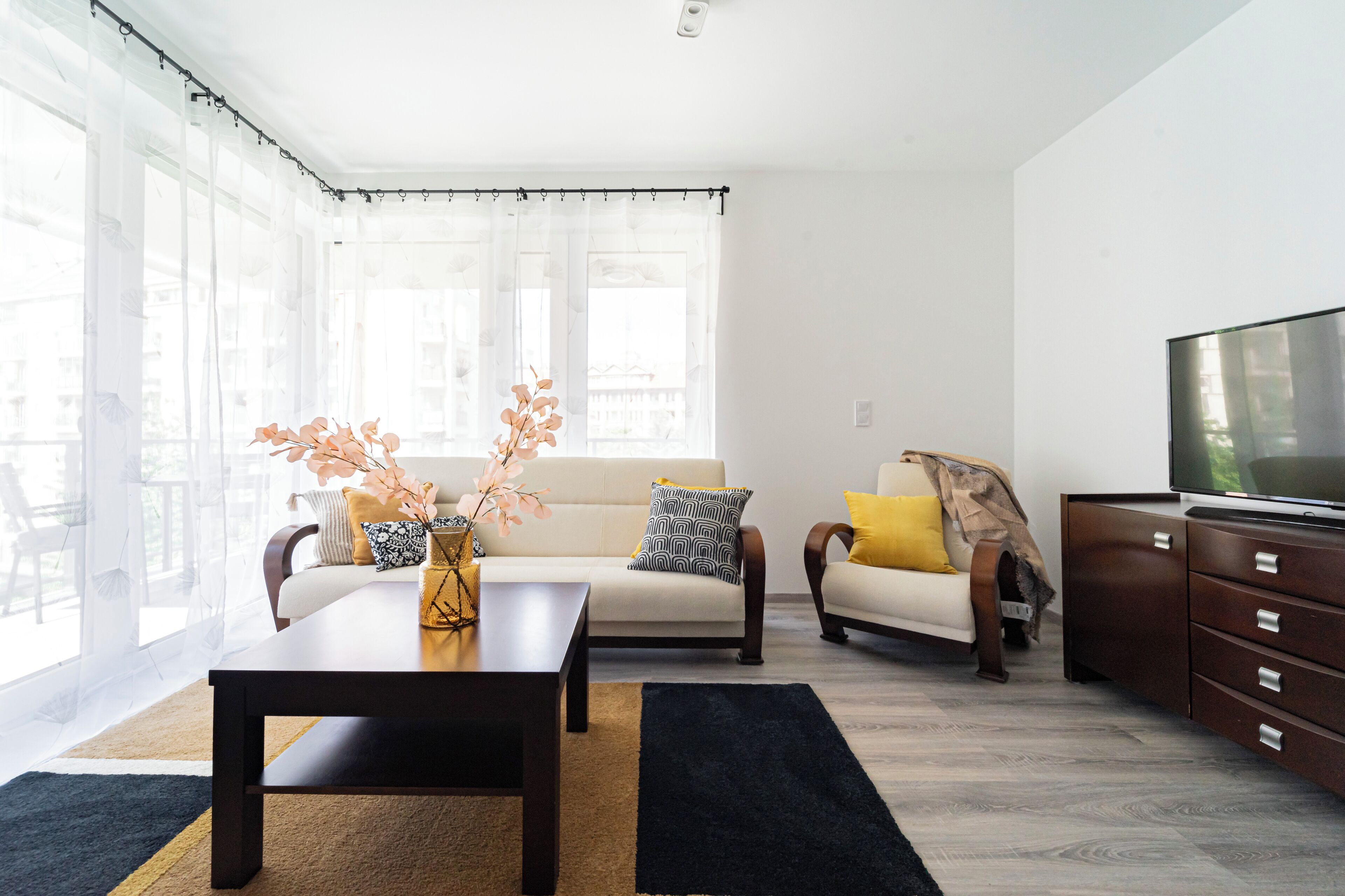 Deluxe Two Bedroom Apartment | Living area | 60-inch Smart TV with cable channels