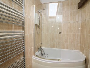 A modern bathroom with a freestanding bathtub, a glass-enclosed shower, and a towel rack. - Tegfan (Newport)
