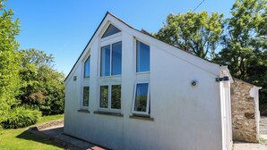 A small, white, single-story building with a gabled roof and three windows. - Tegfan (Newport)