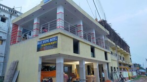 A hotel with a sign reading "BLUE STONE HOTEL & RESTAURANT." - BLUESTONE HOTEL & RESTAURANT (Kanthi)