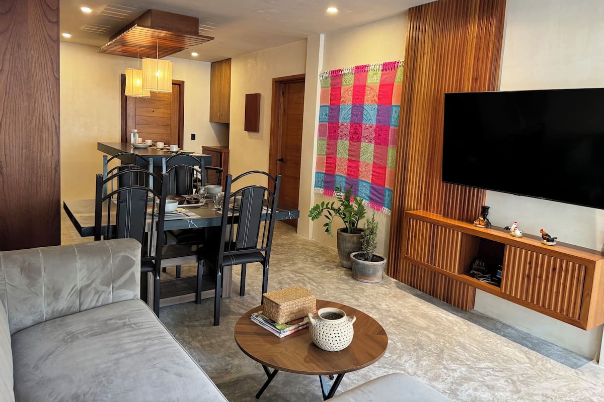 Exclusive Apartment | Living area | 60-inch flat-screen TV with digital channels