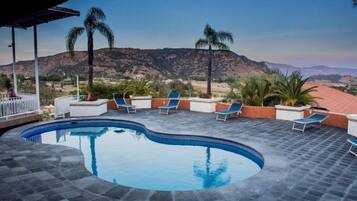 Relax by the pool with a breathtaking view of the surrounding mountains.