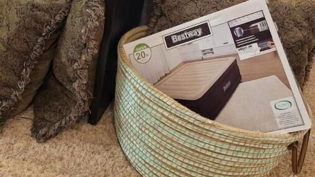 A living room with a sofa, a coffee table, and a basket containing a box of Bestway blankets. - Cozy, quiet 3 bdrm home nearby local amenities (Columbus)