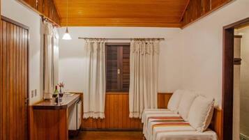 Cozy retreat with a bed, desk, and window for a peaceful stay.