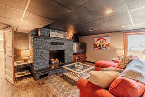 Smart TV, fireplace, books, computer monitors