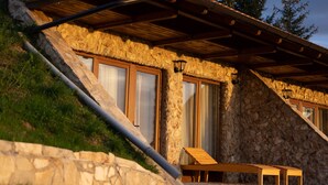 A stone building with a sloped roof and large windows. - Zemunice Kneževic  (Banja Luka)