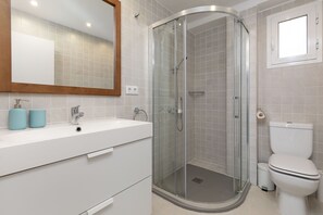 A modern bathroom with a glass-enclosed shower, a white sink, and a toilet. - Port Area II. WiFi + Air Condition (Valencia)