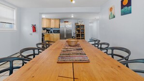 A modern kitchen with wooden cabinets, a stainless steel refrigerator, and a microwave.
